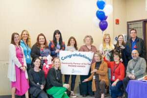Compass Health staff and school staff pose for a photo together at Options High School